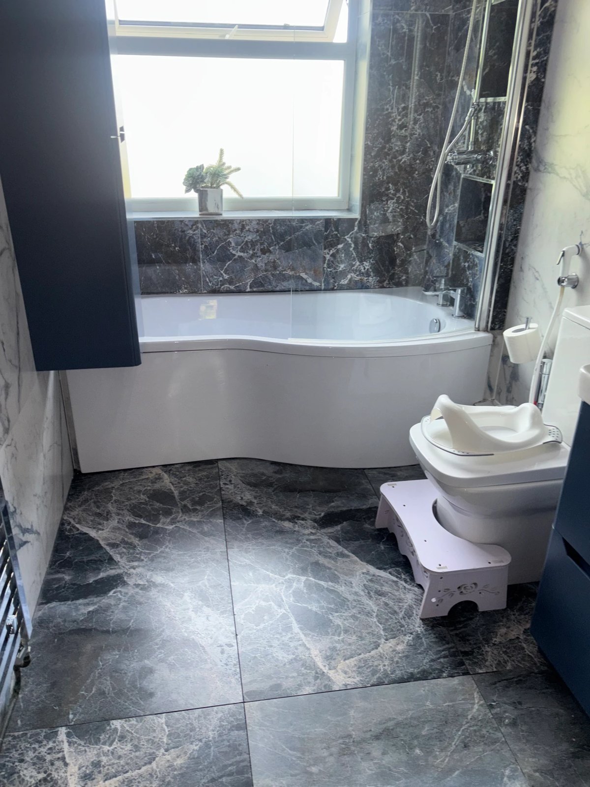 Freshly cleaned bathroom floor, bath and shower area