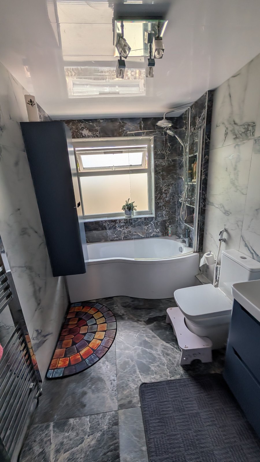 Freshly cleaned bathroom showing the bath, shower, toilet and polished floor